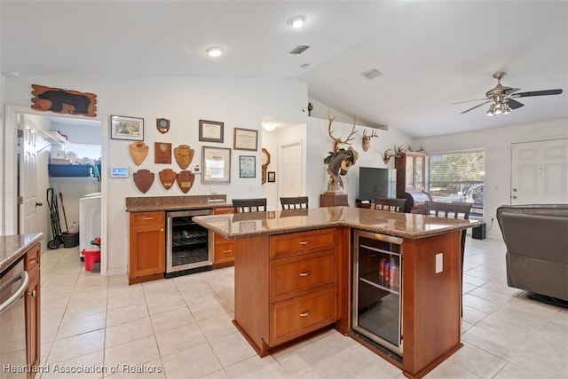 kitchen with beverage cooler, dishwasher, and a center island