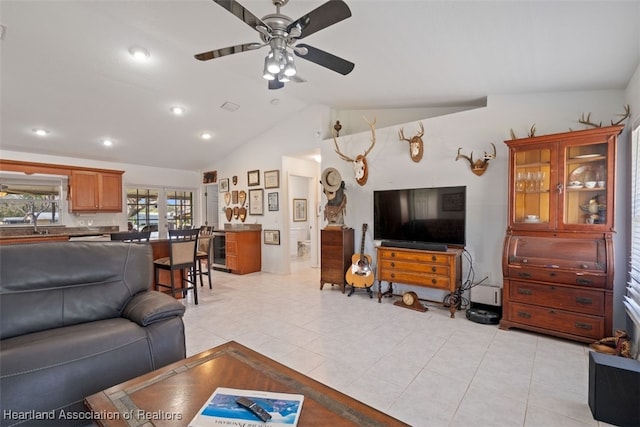 tiled living room featuring vaulted ceiling and ceiling fan