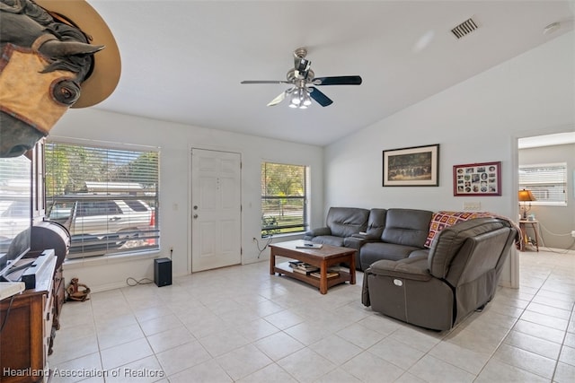 living room with lofted ceiling, ceiling fan, and light tile patterned flooring