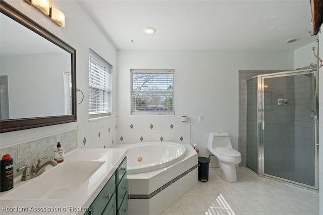 full bathroom featuring vanity, tile patterned floors, shower with separate bathtub, and toilet