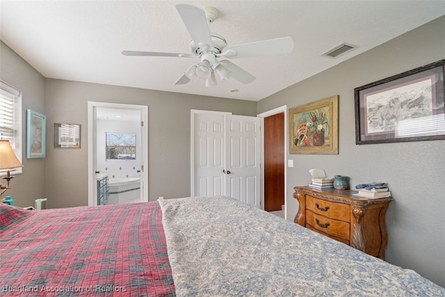 bedroom with ceiling fan and ensuite bath