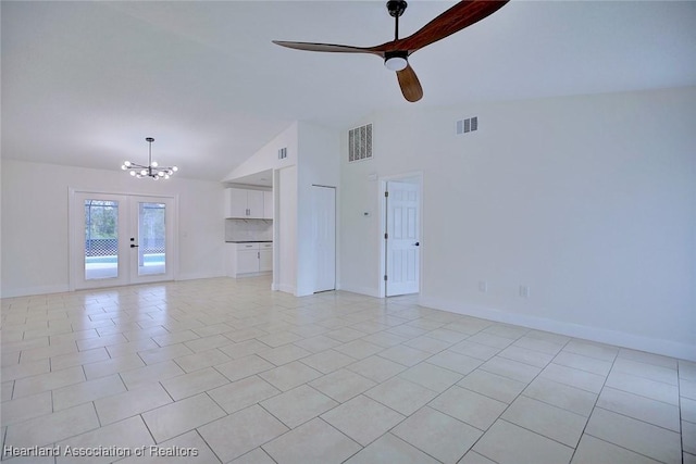 unfurnished living room with visible vents, vaulted ceiling, and light tile patterned floors