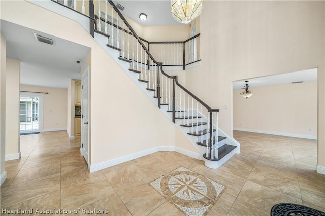 stairway featuring a chandelier