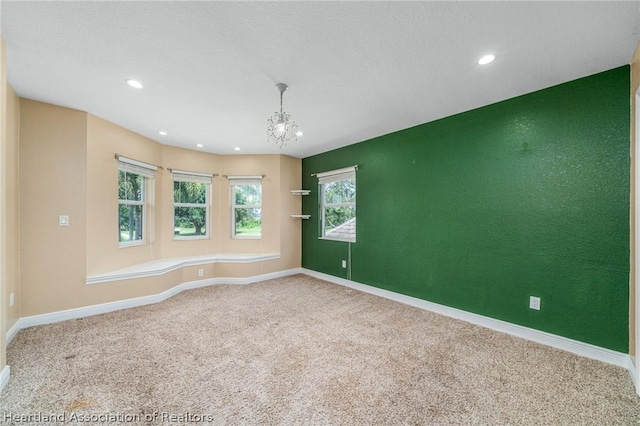 unfurnished room featuring carpet flooring and a notable chandelier