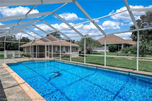 view of pool featuring a patio, a lanai, and a lawn