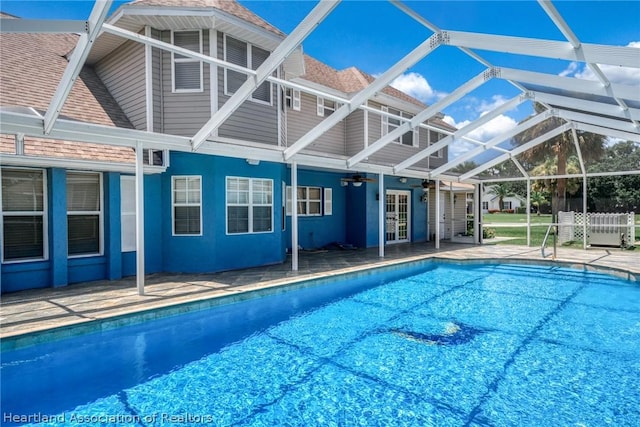 view of pool with a patio area and a lanai