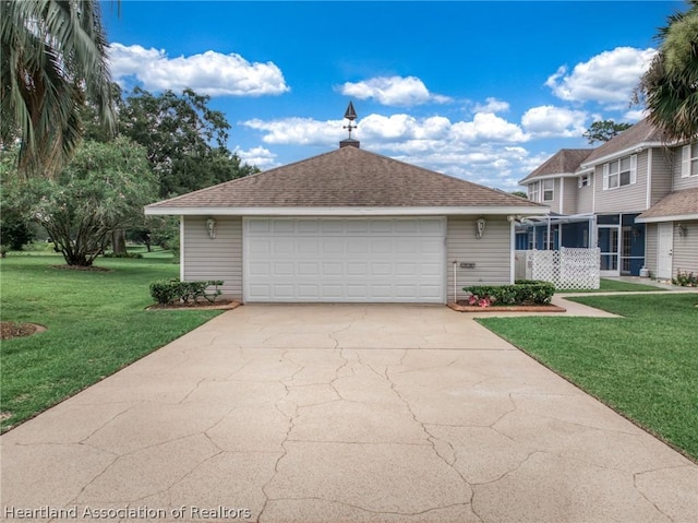 view of front of house featuring a garage and a front lawn