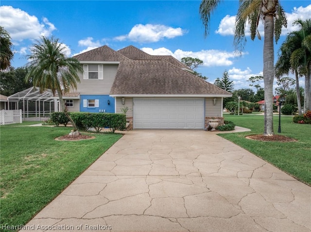 view of front of house featuring a garage, a lanai, and a front yard