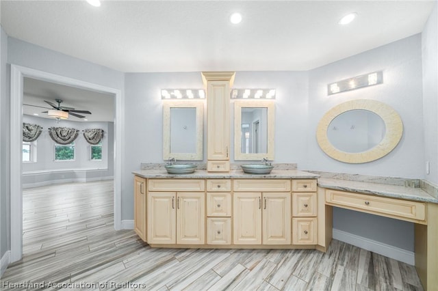 bathroom with ceiling fan, vanity, and wood-type flooring