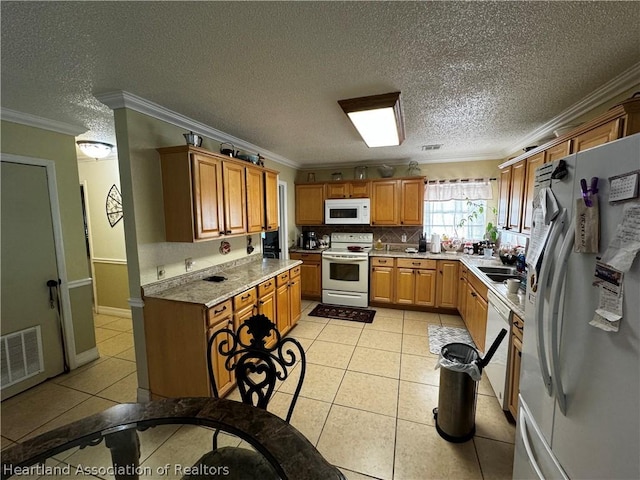 kitchen featuring a textured ceiling, white appliances, crown molding, and light tile patterned floors