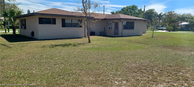 view of front of home featuring a front yard and stucco siding