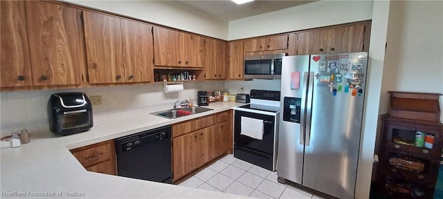 kitchen with light tile patterned floors, tasteful backsplash, stainless steel appliances, light countertops, and a sink