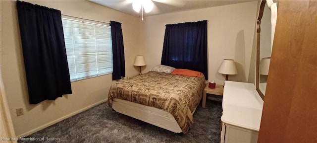 carpeted bedroom featuring ceiling fan and baseboards