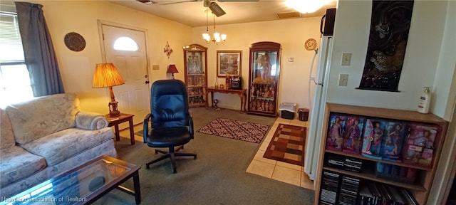 living area featuring tile patterned flooring and ceiling fan