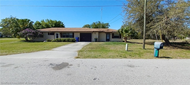 ranch-style home featuring an attached garage, driveway, a front lawn, and stucco siding