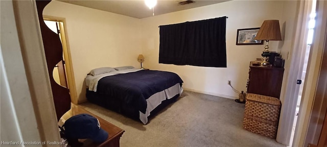 bedroom featuring baseboards, visible vents, and carpet flooring