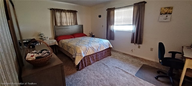 bedroom featuring carpet floors and baseboards