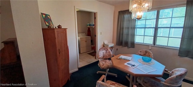 dining room with washer / clothes dryer and an inviting chandelier