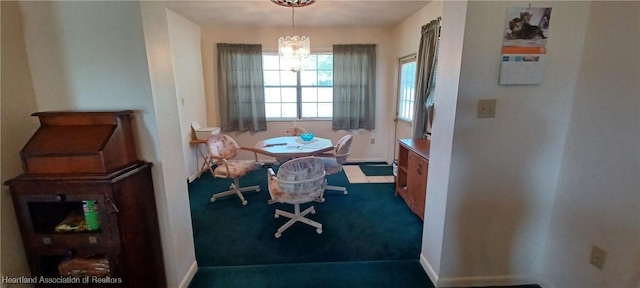 dining space featuring a chandelier and baseboards