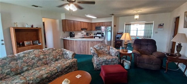 living room featuring ceiling fan and visible vents