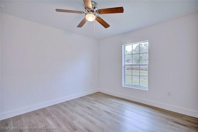 spare room featuring ceiling fan and light wood-type flooring