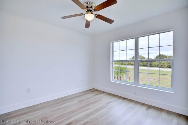 empty room with ceiling fan and light wood-type flooring