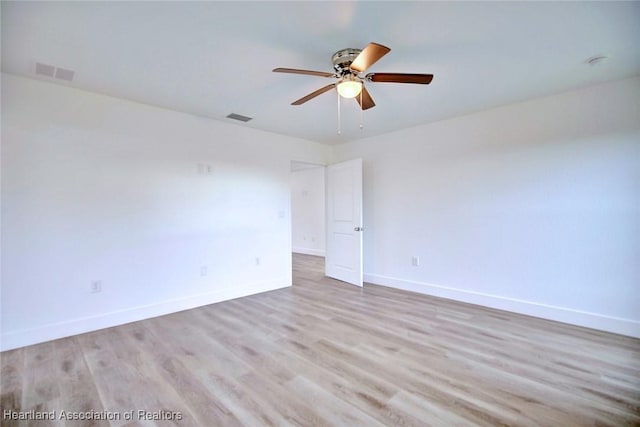 spare room with ceiling fan and light wood-type flooring