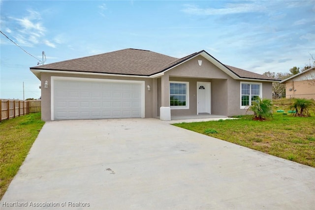 single story home featuring a front lawn and a garage