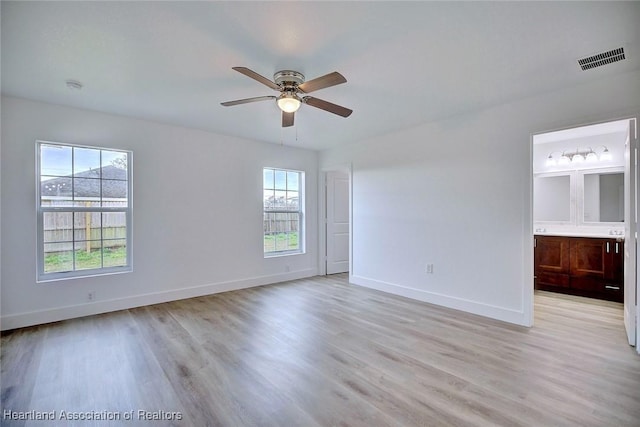 unfurnished room featuring light wood-type flooring, plenty of natural light, and ceiling fan