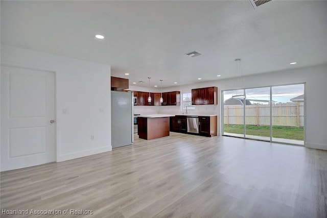 unfurnished living room featuring light hardwood / wood-style flooring and sink