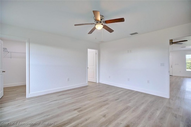 spare room with light wood-type flooring and ceiling fan