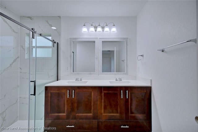 bathroom with vanity and a shower with shower door