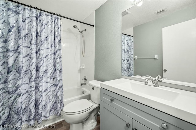 full bathroom featuring a textured ceiling, vanity, toilet, and shower / bathtub combination with curtain