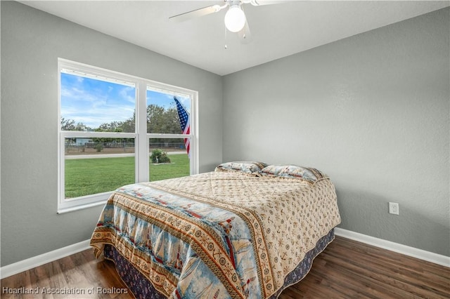 bedroom with ceiling fan and dark hardwood / wood-style flooring