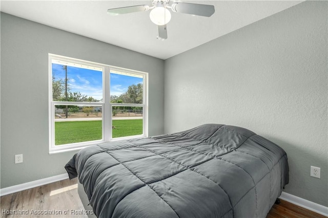 bedroom with ceiling fan and wood-type flooring