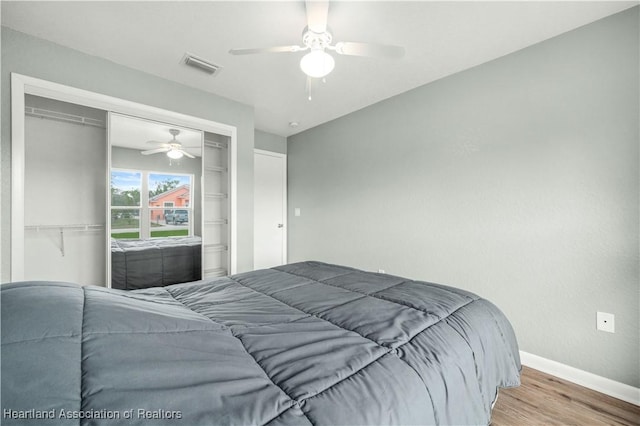 bedroom with ceiling fan, light hardwood / wood-style flooring, and a closet