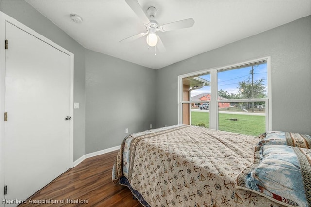 bedroom with ceiling fan and dark hardwood / wood-style floors