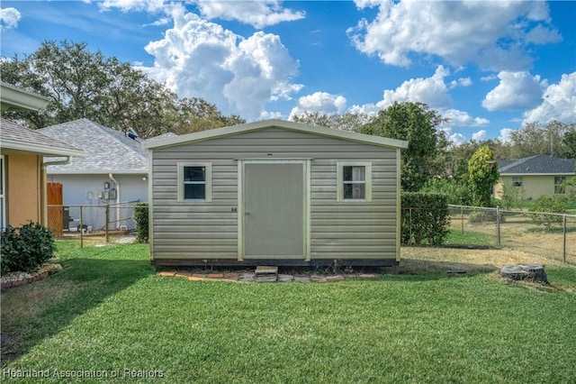 view of outbuilding with a lawn