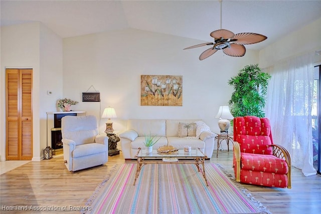 living area featuring vaulted ceiling, wood finished floors, and ceiling fan