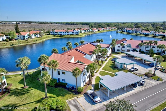 drone / aerial view with a water view and a residential view