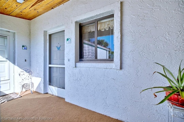 entrance to property featuring stucco siding