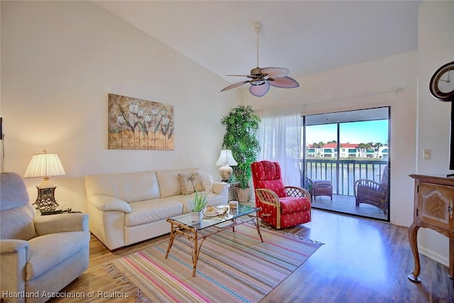 living room with ceiling fan, a water view, high vaulted ceiling, and wood finished floors