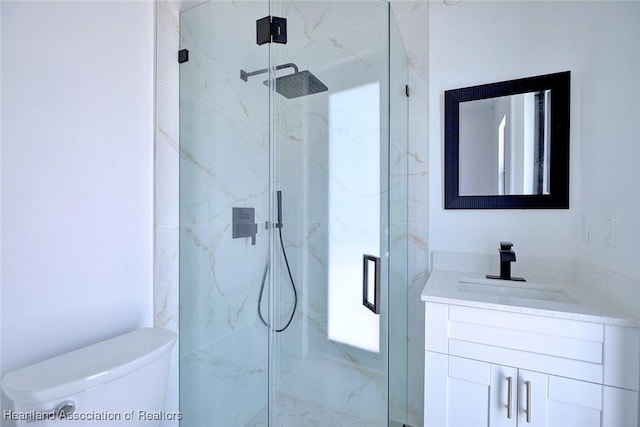 full bathroom with vanity, toilet, and a marble finish shower