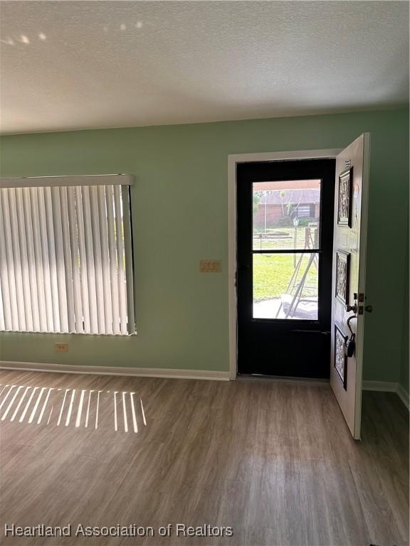 entrance foyer with a textured ceiling and hardwood / wood-style flooring