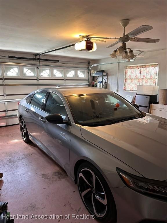 garage featuring a garage door opener and ceiling fan