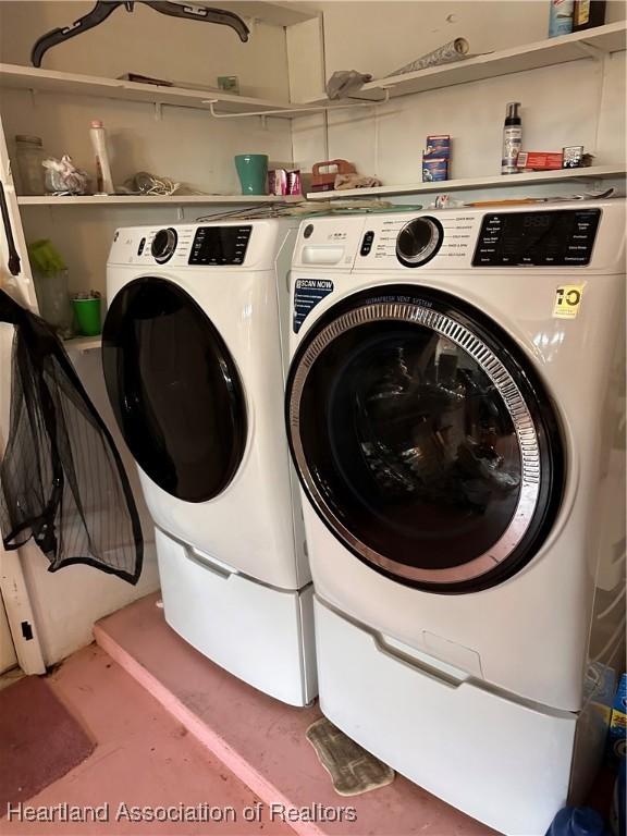 clothes washing area featuring washer and clothes dryer