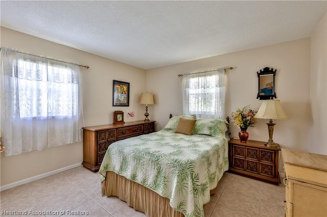 tiled bedroom with a textured ceiling