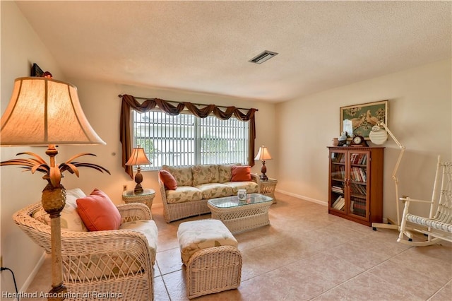 living room featuring light tile patterned floors and a textured ceiling