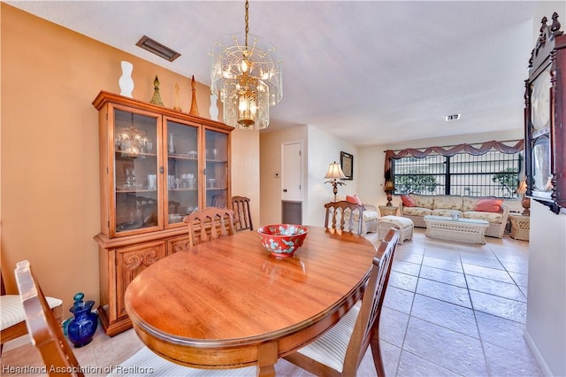 dining room featuring a notable chandelier and light tile patterned floors