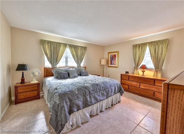 bedroom with light tile patterned flooring and a textured ceiling